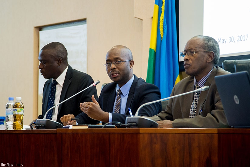 Murangwa presents results on current status of labour as Senator Laurent Nkusi (R) and Deputy Ombudsman Clement Mukeshabatware look on. (Photos by Faustin Niyigena)