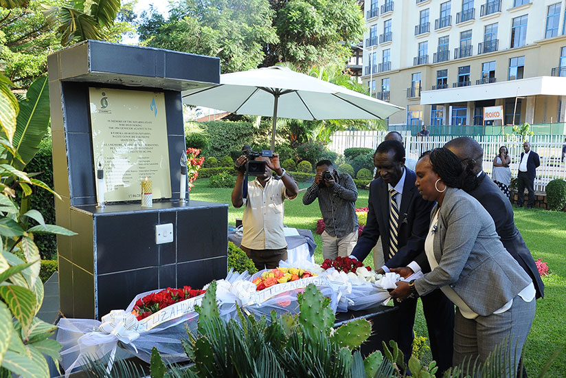 SONARWA Managing Director Tony Twahirwa, Aina Ademola SONARWA Life Managing Director and Annonciata laying wreaths on a monument at the company's headquarters.