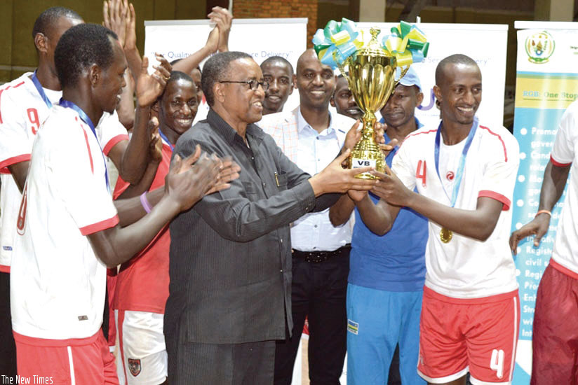 INATEK Vice Chancellor Prof. Silas Lwakabamba lifts the Genocide Memorial Volleyball tournament trophy last year. / File