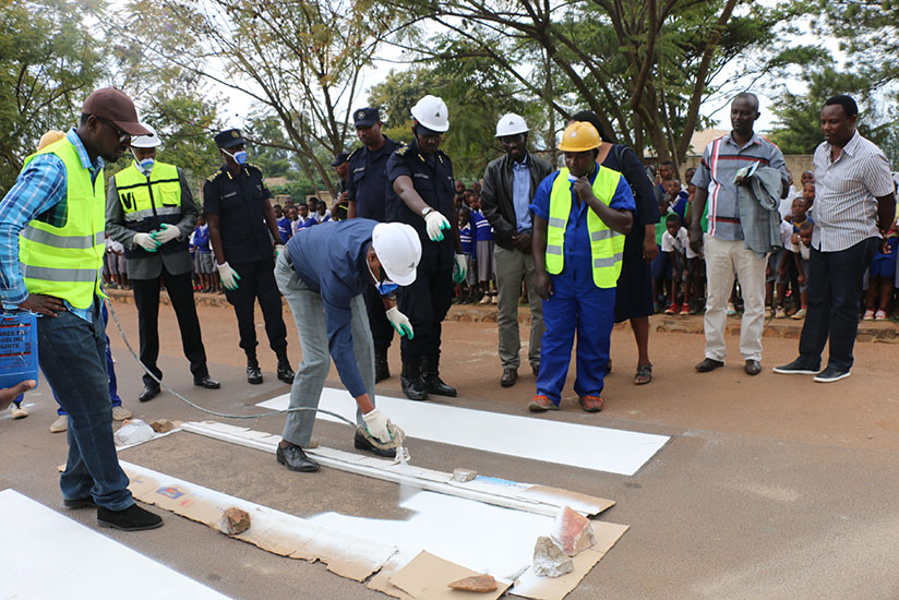 City of Kigali vice mayor in charge of economic development, Parfait Busabizwa, painting a zebra crossing at the official launch. / Courtesy