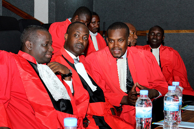 Prosecutor General Jean Bosco Mutangana (R) chats with his colleagues during the the opening of the Judicial Year at parliament last year. / File