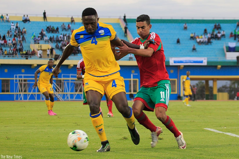 Amvubi midfielder Djihadi Bizimana, who opened the scoring, vies for the ball with Morroco's Rassouany Hamza on Friday. Sam Ngendahimana.