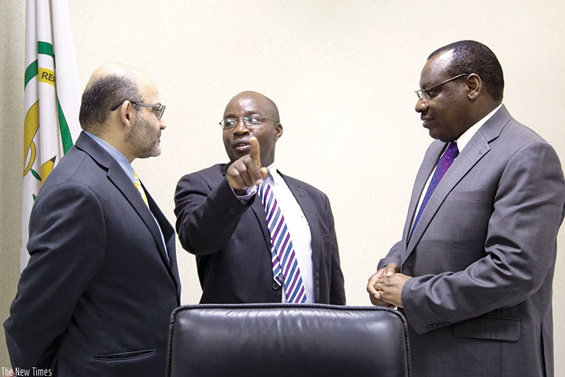 State Minister for Transport Alex Nzahabwanimana (C) chats with World Bank country manager Yasser El-Gammal (L) and Finance and Economic Planning minister Claver Gatete. The Government and the World Bank Group have signed a financing agreement worth Rwf71 billion for rehabilitation of the road linking Ngoma and Nyanza districts. Timothy Kisambira.