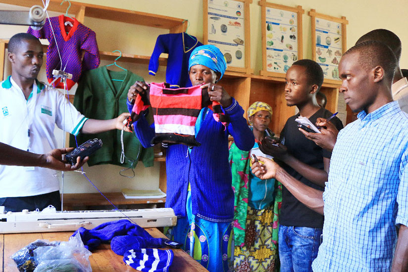 Beatrice Mukabutera, a member of the group, displays some of the products the women make. (Photos by Hudson Kuteesa)