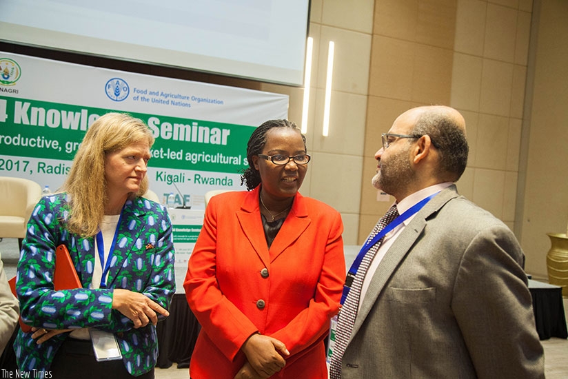 The Minister for Agriculture, Gerardine  Mukeshimana (C), chats with other officials after the meeting yesterday in Kigali. (All photos by Nadege Imbabazi)