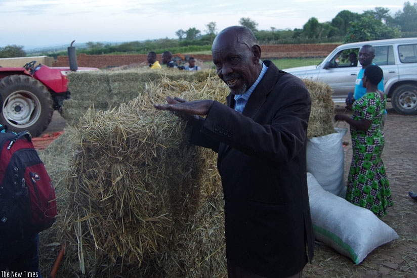 Karani showing some of his grass bales.  (Courtesy)
