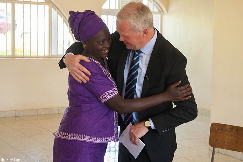 Hjalmarsson hugs Nyiramisago as he handed her a reparation package in Kigali yesterday. (Nadege Imbabazi)