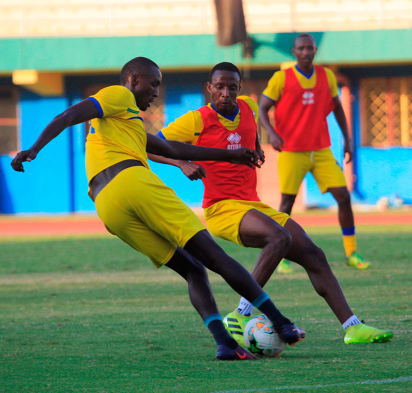 Ernest Sugira (L) takes on Emery Bayisenge during Wednesday morning training session at Amahoro stadium. Amavubi depart for Bangui on Friday. rn/ Sam Ngendahimana