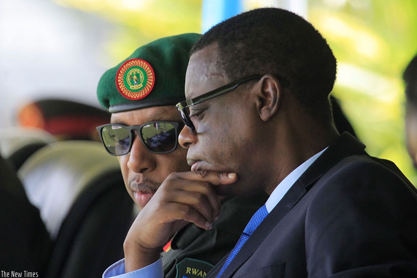 Defence Minister James Kabarebe (R) consults with RDF Chief of Defence Staff Gen Patrick Nyamvumba during the graduation ceremony in Musanze District, yesterday. Sam Ngendahimana. 