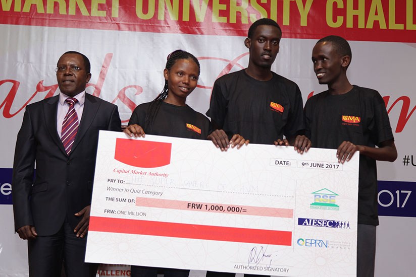 Robert Mathu, CMA executive director (L), with students from CAVM during the award ceremony. / Appolonia Uwanziga