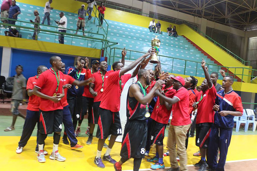 REG players and coaching staff lift their title in celebration after winning the GMT regional edition on Sunday at Amahoro indoor stadium. (G. Asiimwe)