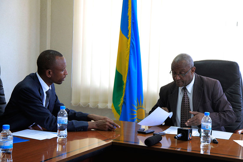 Presidential Candidate Gilbert Mwenedata hands documents to Electoral Commission chairman Kalisa Mbanda in Kigali (Sam Ngendahimana)