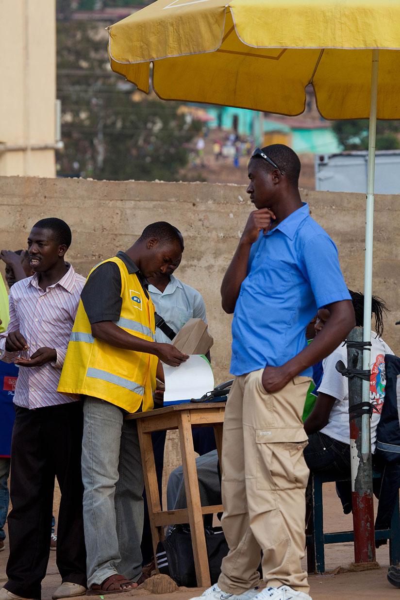 A mobile money user sends money across the border. / Timothy Kisambira