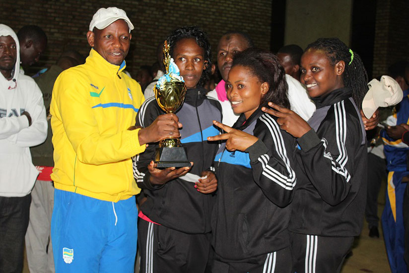 Jean de Dieu Masumbuko with RRA women volleyball team after winning last year's Alphonse Rutsindura memorial tournament. / File