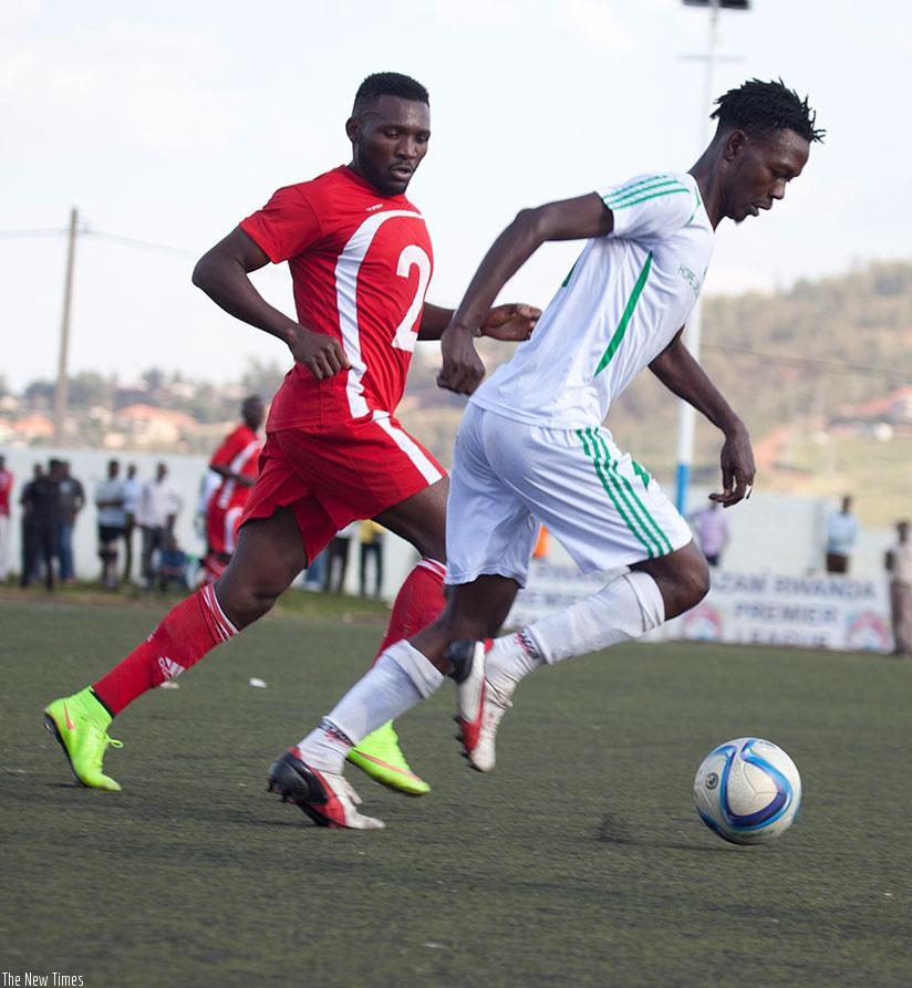 SC Kiyovu's striker Jean Lomami tries to dribble past an Espoir player during a recent league game. (S. Ngendahimana)