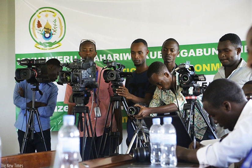 Local media practitioners cover a past event. (Sam Ngendahimana)