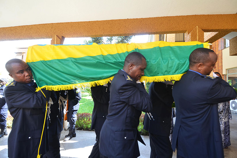 Police officers carrying the body of the deceased MP as they make an entrance to Parliament where she was honoured for her service to the country. / Sam Ngendahimana