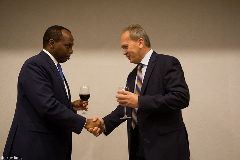 Gatare (L) and Dr Nikitin toast during the event in Kigali. (Timothy Kisambira)