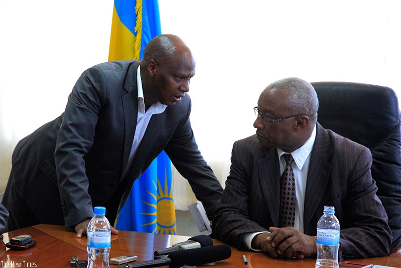 Munyaneza (L) consults with NEC chairperson Kalisa Mbanda during the submission of nomination forms on Monday. (Sam Ngendahimana)