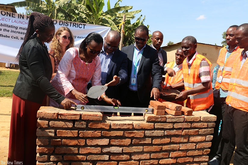 Kamuyumbu (L), Angelique Mukunde, the kicukiro vice-mayor in charge of finance (2nd left),  Sano (1st right) and other officials lay the foundation stone for the works in Masaka. John Mbaraga.