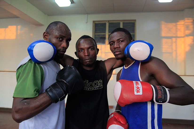 Boxers Vincent Nsengiyumva (L) David Nsabimana (C) and Jean-Pierre Cyiza pose for a photo after training as they prepared for the African Championships. / Sam Ngendahimana