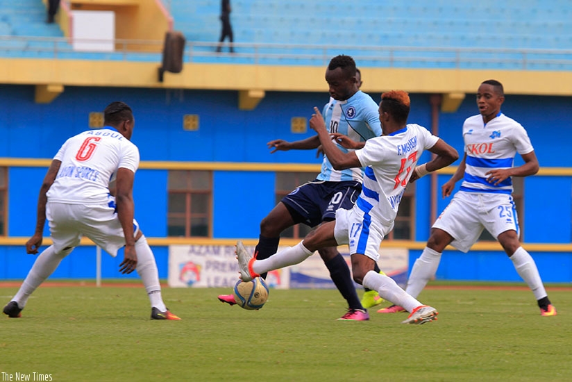 Police striker Danny Usengimana tries to dribble past Rayon players during a recent league game. (Sam Ngendahimana)