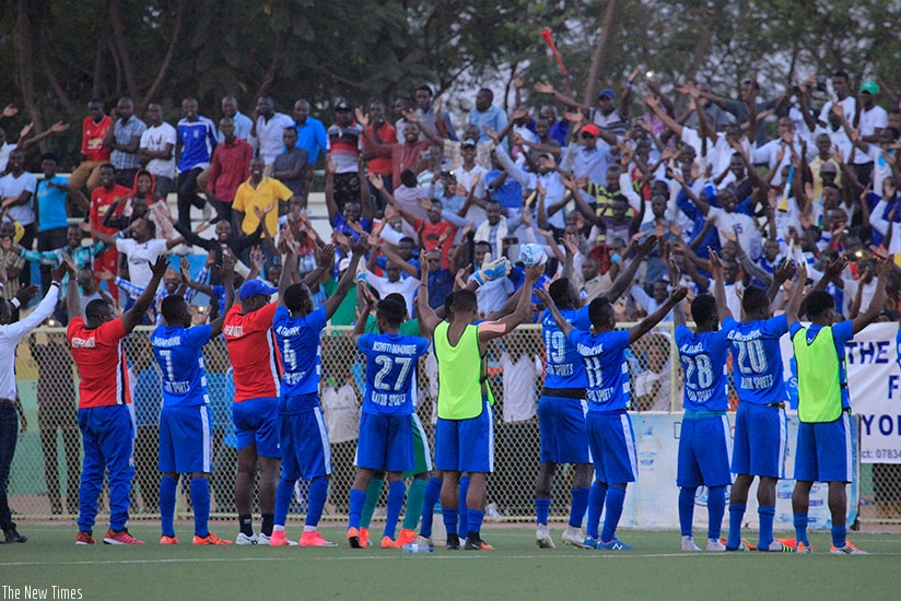 Rayon Sports players join fans in their legendary clap celebration after holding APR to a one-all draw at Stade de Kigali in May. (Sam Ngendahimana)