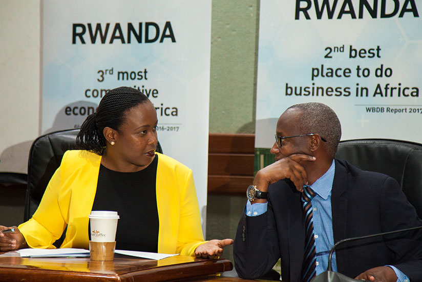 Clare Akamanzi, the CEO of RDB, chats with Stephen Ruzibiza, CEO of the Private Sector Federation, during press conference yesterday. / Nadege Imbabazi