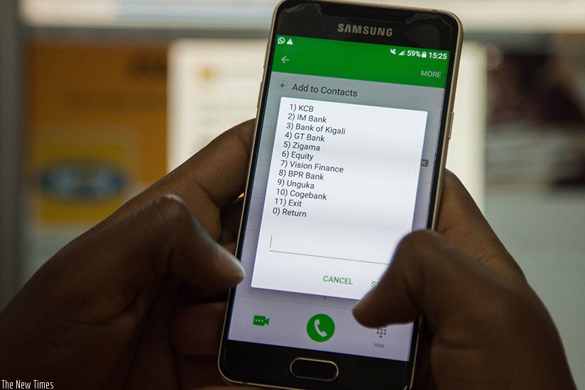 A mobile phone user displays a banking app. Rwanda's mobile phone penetration rate is at 72.6% as of April, according to latest figures by RURA, the sector regulator.  (File)