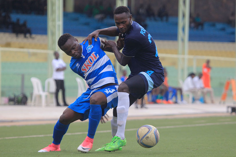 Rayon Sports midfielder Pierrot Kwizera (L) vies for the ball with a Police FC defender during the second leg match on Wednesday. / Sam Ngendahimana