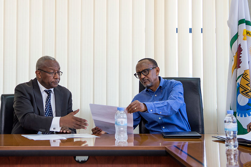 President Kagame presents his candidature documents to the National Electoral Commission chairperson, Kalisa Mbanda, yesterday. Addressing local and international media after the e....
