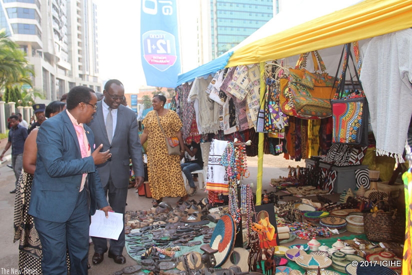 Minister Kanimba (middle) and city officials inspect the exhibition yesterday. / Francis Byaruhanga.