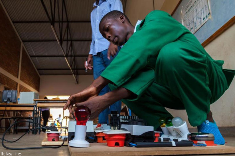 Rogers Dushimiyimana, a former TVET student of Alliance High School, performs an experiment. File.