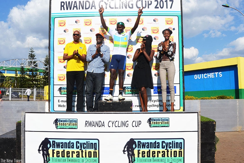 Gasore Hategeka raises his arms in the air to celebrate after winning the road race on Sunday at Amahoro stadium. Sam Ngendahimana.