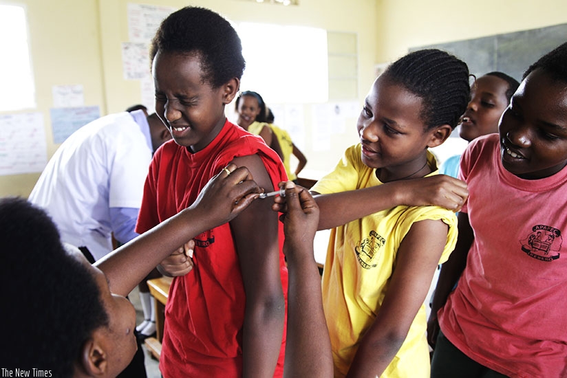 Seraphine Mukanyarwaya, a nurse at Kagugu Health Centre in Kigali, immunises pupils of APAPEC Irebero Primary School. / File