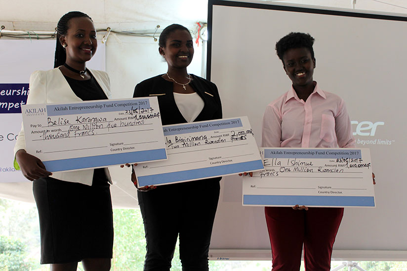 The winners pose with dummy cheques for their cash prizes. / Francis Byaruhanga