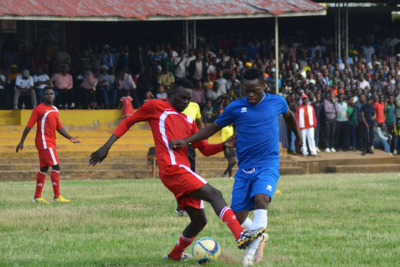 Rayon Sports midfielder Pierrot Kwizera tries to dribble past Espoir defender at Kamarampaka Stadium in Rusizi. / Sam Ngendahimana