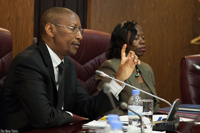 National Bank of Rwanda Governor John Rwangombwa addresses participants as Vice Governor, National Bank of Rwanda Dr. Monique Nsanzabaganwa listens during the press conference yest....