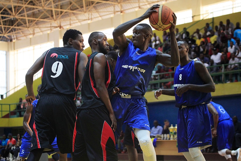 Espoir's Pascal Niyonkuru (with the ball) in action against REG during Genocide memorial tournament at Amahoro indoor stadium. (S. Ngendahimana)