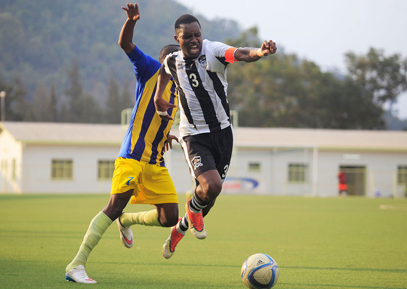 Army side's right-back Albert Ngabo tries to dribble past Amagaju midfielder Arafati Sibomana during the match at Kigali Stadium. / Courtesy
