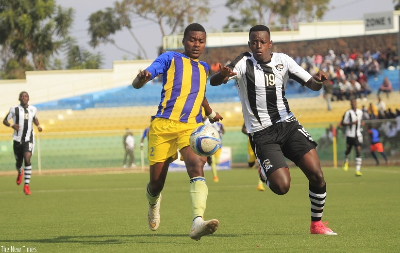 APR's Innocent Nshuti who scored the fifth goal battles for the ball with Amagaju FC skipper Noel Bizimana during the return leg on Thurday at Stade de Kigali (Sam Ngedahimana)