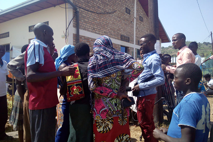 Some of the journalists attending the training interview people in Ruhango District as part of the field study. / Appolonia Uwanziga