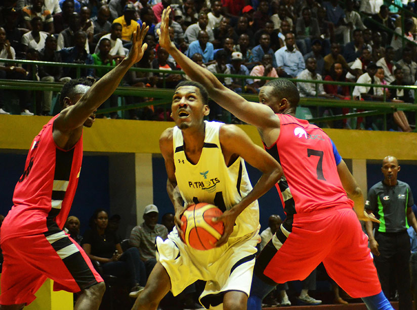 Patriots' centre player Jean de Dieu Ntagunduka tries to drop two points as two REG players try to block him in a recent league match. / Sam Ngendahimana