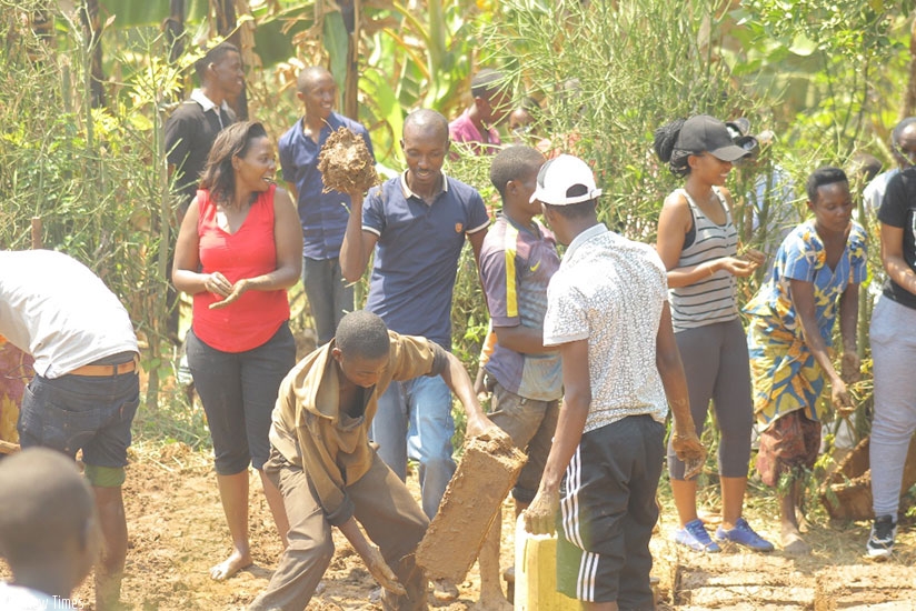 Members participate in the making of bricks for construction of Veneranda Mukandamage's house. (Donata Kiiza)