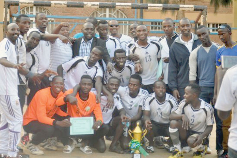 APR players and coaching staff in a group photo with the trophy after winning the Carre d'As title on Monday at Kimisagara ground. (Courtsey)
