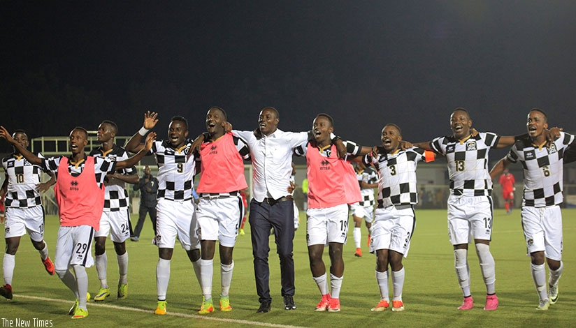 APR FC head coach Jimmy Mulisa and his players celebrate after winning the club's ninth Peace Cup title at Stade de Kigali on Tuesday. (Sam Ngendahimana)