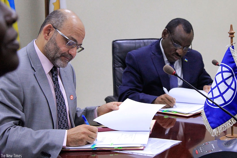 El-Gammal and Minister Gatete sign the agreement in Kigali yesterday. Sam Ngendahimana.