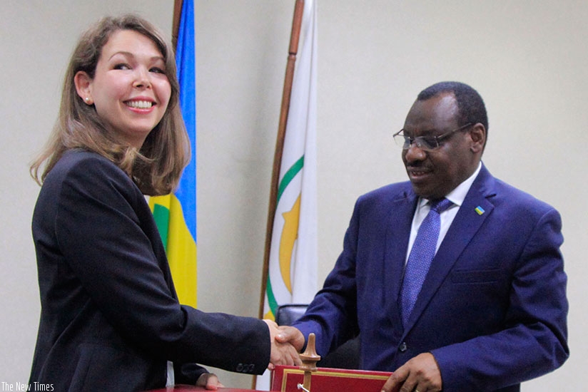Finance Minister Gatete and DFIDu2019s Waples exchange the agreement documents in Kigali. / Samuel Ngendahimana.