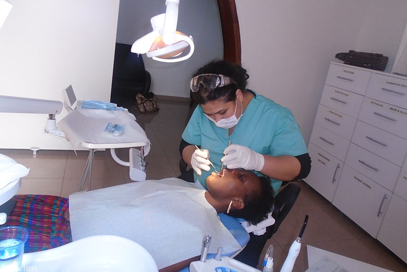 Dr Kristine Mae T Ferrer, a dentist at Deva Medical Consultancy in Nyarutarama, Kigali, attends to a patient with a dental problem./ Lydia Atieno.