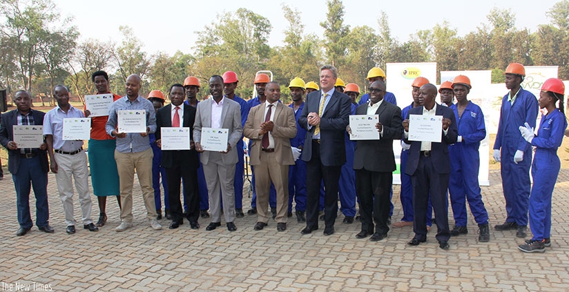Rwamukwaya (6th Left) and Amb. Dr. Woeste (3rd Right), construction companies' managers and apprentices pose for a group photo after the event. (Courtesy)